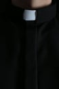 Priest wearing cassock with clerical collar, closeup view