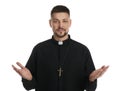 Priest wearing cassock with clerical collar on white background