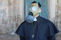 Priest wearing a gas mask