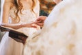 priest wears a wedding ring on bride finger