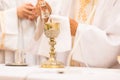 Priest` hands during a wedding ceremony/nuptial mass shallow DOF; color toned image Royalty Free Stock Photo