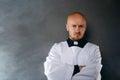 Priest in white surplice and black shirt with cleric collar