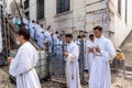 Priests and seminarians descend the stairs of the church Hundreds of people pray during an open-air mass in honor of Nossa Senhora