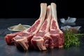 Primal arrangement Uncooked lamb ribs placed on a natural stone tabletop