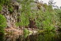 Primal rock on the shore of a calm lake