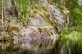 Primal rocky shore of a calm lake in Karelia