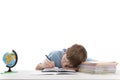 Primare schoolboy with glasses is tired while doing homework. Boy sleeps at his desk Portrait of tired boy on white background Royalty Free Stock Photo