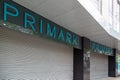 a Primark store with closed shutters on a high street