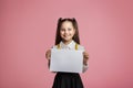 Primary education. Small schoolgirl with happy smile holding sign with free space Royalty Free Stock Photo