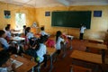 Primary pupil writting on blackboard in school time