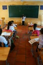 Primary pupil writting on blackboard in school time