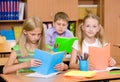 Primary school children in the classroom reading books Royalty Free Stock Photo