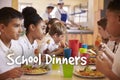 Primary school children eat school dinners in cafeteria Royalty Free Stock Photo