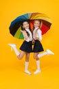 Primary school fashion. Happy school kids with fashion look holding colorful umbrella. Fashion small girls in formal