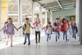 Primary school kids run holding hands in corridor, close up Royalty Free Stock Photo