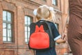 Primary school student and parent go hand in hand. A woman and a young girl with a backpack behind her back. The beginning of the Royalty Free Stock Photo