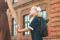 Primary school student and parent go hand in hand. A woman and a young girl with a backpack behind her back. The beginning of the. Royalty Free Stock Photo