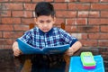 Primary school student in proper school uniform reading book on study table in classroom. Indian education system in Primary Royalty Free Stock Photo