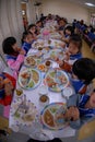 Primary school students eat lunch in the school canteen.