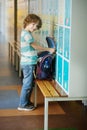 The primary school students standing near lockers in hallway. Royalty Free Stock Photo