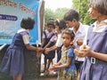 primary school students are washing their hand and their dishes before taking Mid-day meal in a primary school of West Bengal