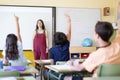 Primary school teacher teaching young students in class Royalty Free Stock Photo