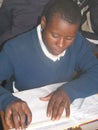 Primary schoolgirl writing in class