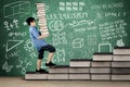 Primary student walking on books stair