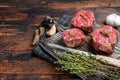 Prime raw Fillet mignon steaks on a wooden board with thyme and garlic. Dark wooden background. Top view. Copy space