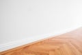 Primed white wall and wooden parquet floor - apartment interior background