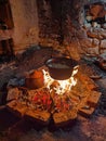 Primitive cooking in ceramic and iron pots on open fires in old stone houses. Royalty Free Stock Photo