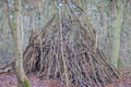 Primitive hut made of tree branches in the Leudal nature reserve Royalty Free Stock Photo