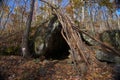 Primitive Lean to Survival Shelter in the forest. Makeshift campsite in the wilderness. Essential bushcraft skill Royalty Free Stock Photo