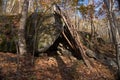 Primitive Lean to Survival Shelter in the forest. Makeshift campsite in the wilderness. Essential bushcraft skill Royalty Free Stock Photo