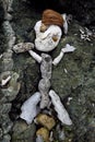 Primitive sculpture of man made of rock, coral and coconuts