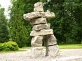 Primitive simple big huge man sculpture from bright square stones park summer