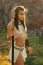 Primitive woman holding a spear. Amazon woman