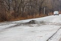 Primorsky Krai, Russia - 2016, autumn - A car drives along a bad, dead road among tall trees. Russian roads. Bad asphalt