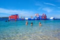 People on an inflatable water attraction.