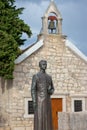 Primosten Croatia July 2020 Statue of a bishop in front of a small old christan church in the town of Primosten