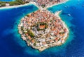 Primosten town, Croatia. View of the city from the air. Seascape with beach and old town. View from drone on the peninsula with ho