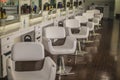 Primp and blow beauty salon row of white chairs aligned the same way