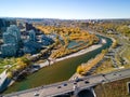 Princes Island Park autumn foliage scenery. Aerial view of Downtown City of Calgary Centre St Bridge