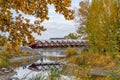 Princes Island Park Peace bridge. Autumn foliage scenery in downtown Calgary Bow river bank Royalty Free Stock Photo