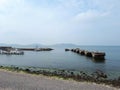 Motorboats and ruined stone pier