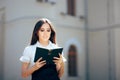 Princess Reading a Book in front of her Castle Royalty Free Stock Photo