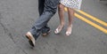 Legs and feet of male and female couple demonstrating dance moves on the street