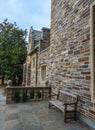 PRINCETON, USA - NOVEMBER 12, 2019: wooden bench near the educational building of Princeton University. New Jersey USA