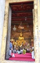 Principle Buddha image through a temple door Royalty Free Stock Photo