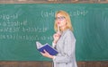 Principles can make teaching effective. Woman teaching near chalkboard in classroom. Effective teaching involve Royalty Free Stock Photo